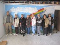 People in front of rainbow wall